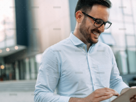 demo-attachment-609-portrait-of-businessman-in-glasses-holding-tablet-AWVHCJU